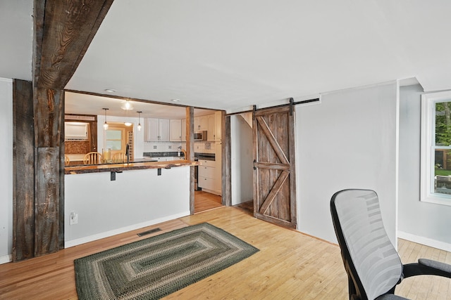 33-34 Gerber Ln, Monmouth, ME 04259 - office with a barn door and light wood finished floors