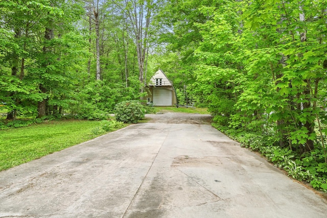 33-34 Gerber Ln, Monmouth, ME 04259 - view of front of home with driveway, an outbuilding, and a front lawn
