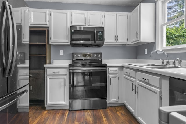 7 Dumas St, Lisbon, ME 04252 - kitchen with stainless steel microwave, freestanding refrigerator, range with electric cooktop, light countertops, and white cabinetry