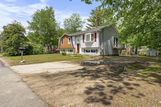 7 Dumas St, Lisbon, ME 04252 - bi-level home featuring a storage shed, a front yard, and a playground