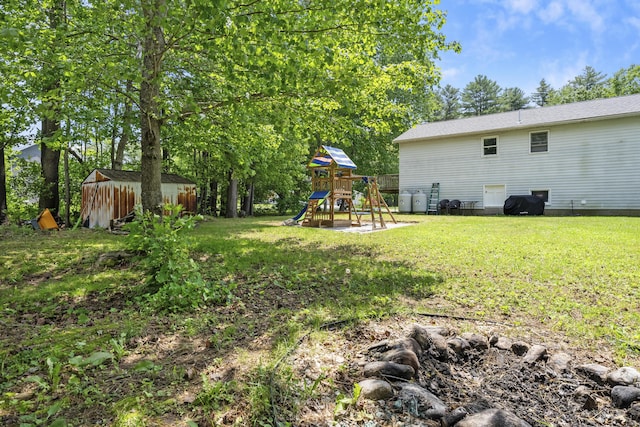 7 Dumas St, Lisbon, ME 04252 - view of grassy yard featuring a shed and a playground