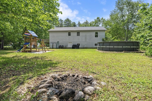 7 Dumas St, Lisbon, ME 04252 - back of house with a playground, a pool, and a yard