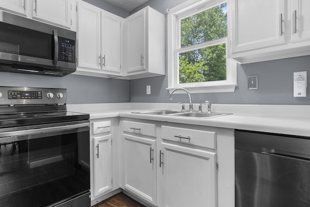 7 Dumas St, Lisbon, ME 04252 - kitchen with stainless steel appliances, light countertops, and white cabinetry