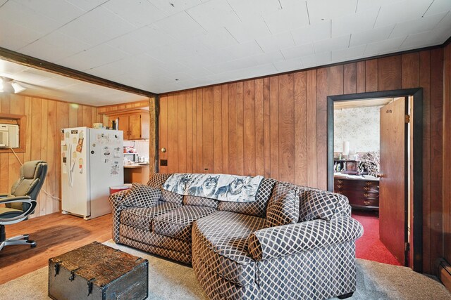 23 Main St, Athens, ME 04912 - living room with wood walls, light wood-style flooring, and a baseboard radiator