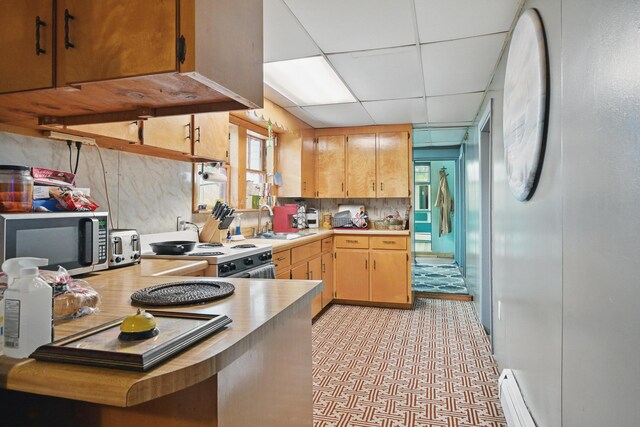 23 Main St, Athens, ME 04912 - kitchen with stainless steel microwave, a sink, light countertops, a paneled ceiling, and white electric range oven