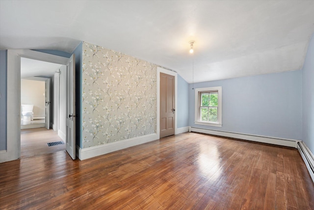 133 Front St, Old Town, ME 04468 - additional living space featuring vaulted ceiling, baseboard heating, wood finished floors, and a baseboard heating unit