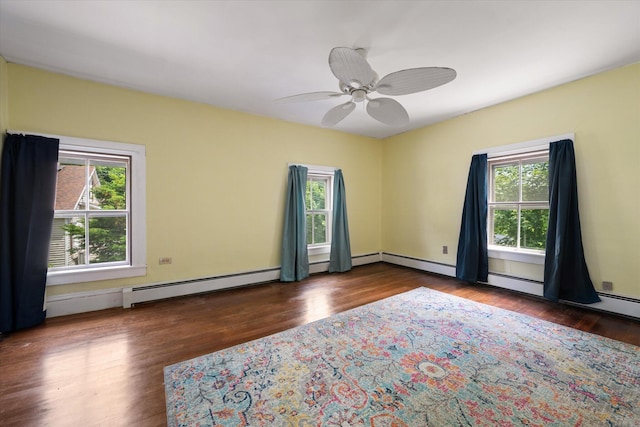 133 Front St, Old Town, ME 04468 - empty room with plenty of natural light, baseboard heating, wood finished floors, and a ceiling fan