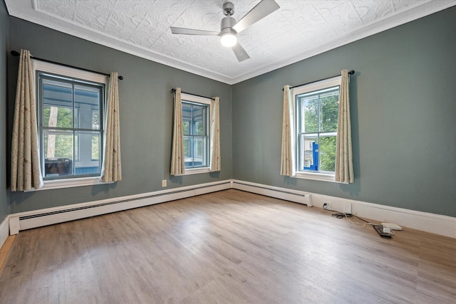 133 Front St, Old Town, ME 04468 - spare room with an ornate ceiling, wood finished floors, crown molding, a ceiling fan, and baseboard heating