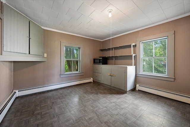 133 Front St, Old Town, ME 04468 - unfurnished dining area with ornamental molding, healthy amount of natural light, a baseboard radiator, and a baseboard heating unit