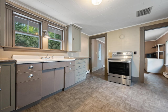 133 Front St, Old Town, ME 04468 - kitchen with stainless steel electric stove, gray cabinets, crown molding, light countertops, and baseboard heating