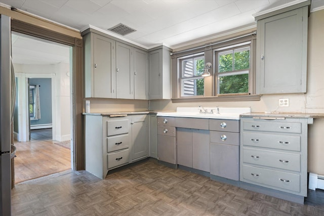 133 Front St, Old Town, ME 04468 - kitchen featuring gray cabinets, light countertops, and a baseboard radiator