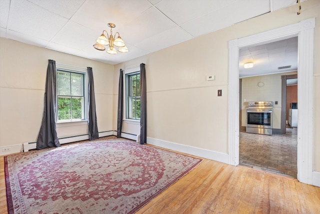 133 Front St, Old Town, ME 04468 - unfurnished room with wood finished floors and a chandelier