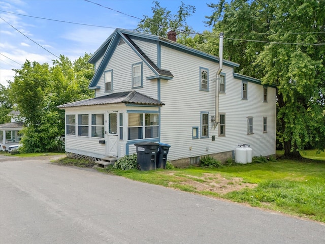 133 Front St, Old Town, ME 04468 - view of front of property featuring a chimney and a sunroom