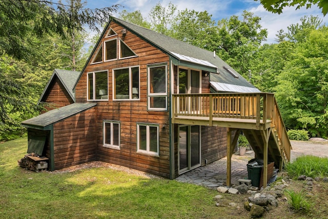 12 Michaud Ln, Bridgton, ME 04009 - back of property featuring a wooden deck, a yard, stairway, and a shingled roof