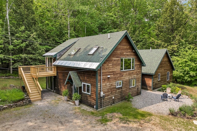 12 Michaud Ln, Bridgton, ME 04009 - chalet / cabin with a fire pit, stairs, a wooden deck, a forest view, and a shingled roof