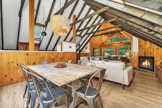 12 Michaud Ln, Bridgton, ME 04009 - dining area featuring wooden walls, light wood finished floors, and a glass covered fireplace
