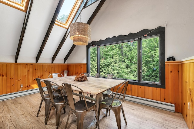 12 Michaud Ln, Bridgton, ME 04009 - dining room featuring wooden walls, healthy amount of natural light, a chandelier, a baseboard radiator, and light wood finished floors