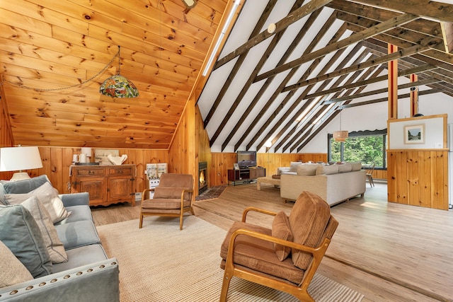 12 Michaud Ln, Bridgton, ME 04009 - living area featuring lofted ceiling, wood walls, and light wood-type flooring