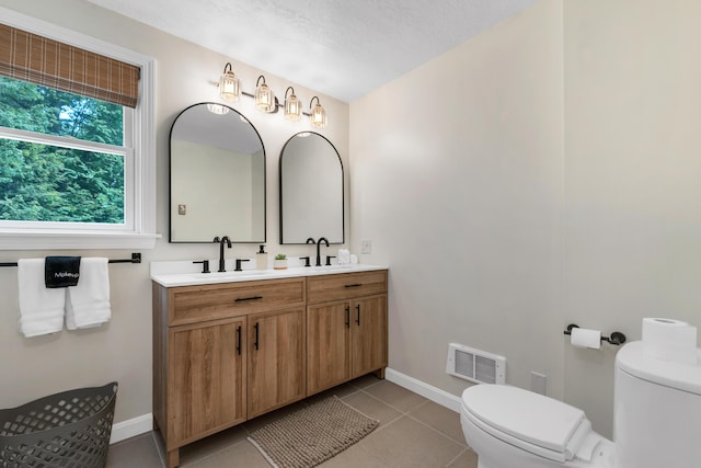 12 Michaud Ln, Bridgton, ME 04009 - full bathroom with toilet, baseboards, double vanity, and tile patterned flooring