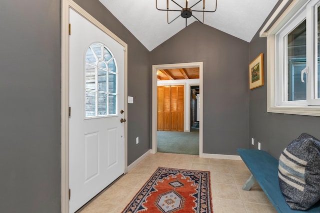 12 Michaud Ln, Bridgton, ME 04009 - foyer entrance featuring lofted ceiling, a chandelier, light tile patterned floors, and baseboards