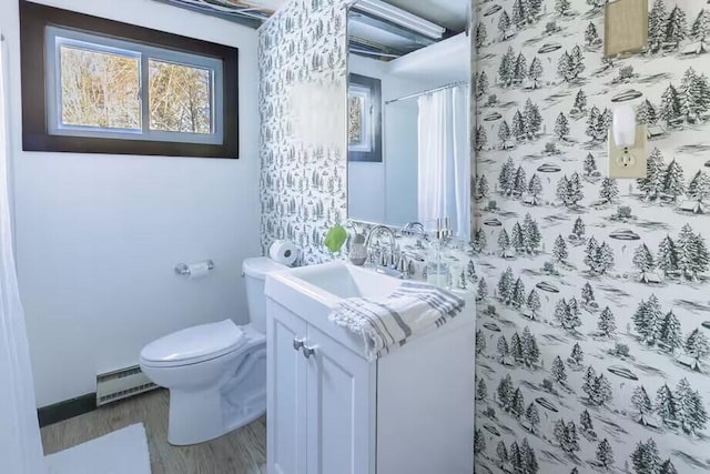 12 Michaud Ln, Bridgton, ME 04009 - full bathroom featuring a baseboard heating unit, vanity, toilet, wood finished floors, and baseboards