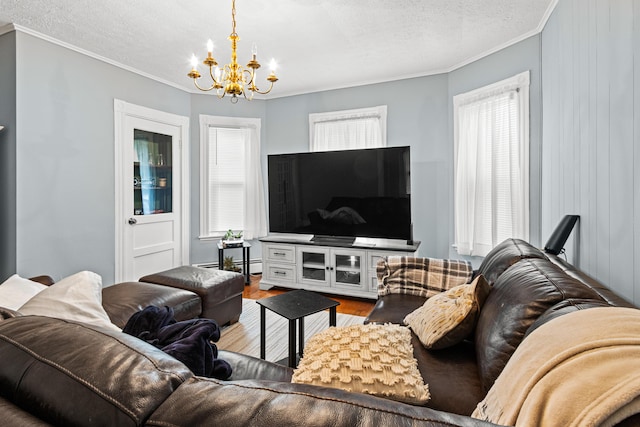 22 Union St, Biddeford, ME 04005 - living area with a chandelier, crown molding, wood finished floors, and a textured ceiling