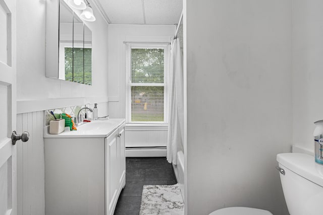 22 Union St, Biddeford, ME 04005 - bathroom featuring a baseboard heating unit, vanity, toilet, and tile patterned flooring
