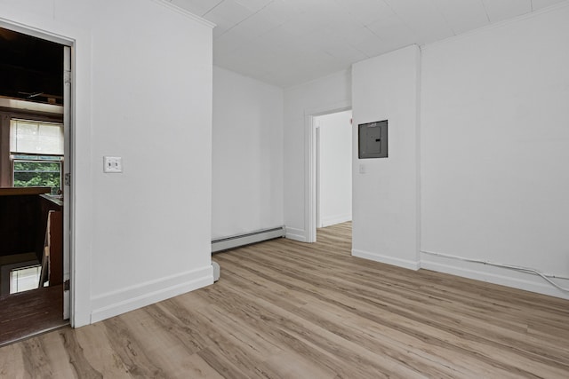 22 Union St, Biddeford, ME 04005 - unfurnished room featuring baseboard heating, light wood-style floors, baseboards, crown molding, and electric panel