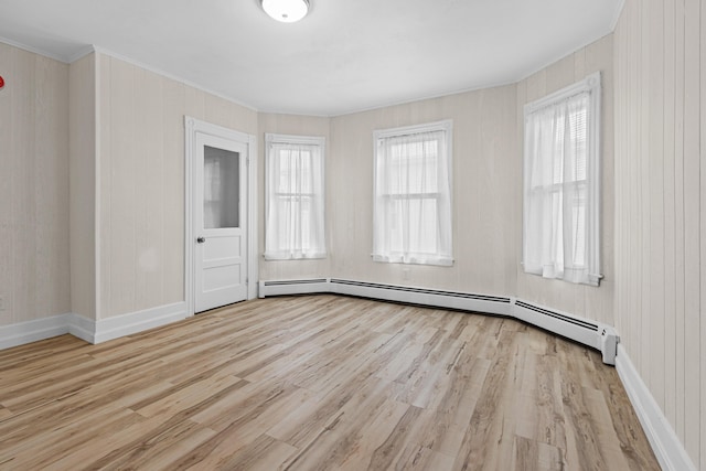 22 Union St, Biddeford, ME 04005 - spare room featuring crown molding, wood finished floors, baseboards, and a baseboard radiator