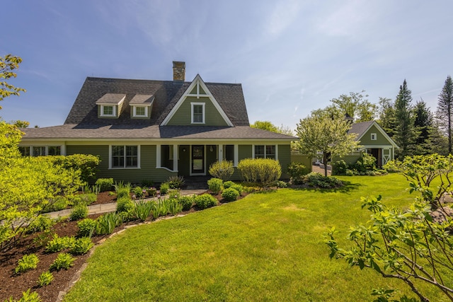 321 Beech Hill Rd, Northport, ME 04849 - view of front of home featuring a front lawn, a chimney, and a shingled roof