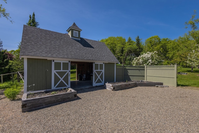 321 Beech Hill Rd, Northport, ME 04849 - rear view of property with an outdoor structure and a shingled roof