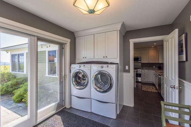 321 Beech Hill Rd, Northport, ME 04849 - laundry room with washer and dryer, wainscoting, cabinet space, and dark tile patterned floors