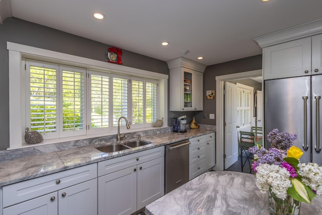 321 Beech Hill Rd, Northport, ME 04849 - kitchen featuring stainless steel appliances, a sink, recessed lighting, glass insert cabinets, and light stone countertops