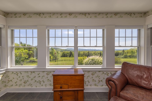 321 Beech Hill Rd, Northport, ME 04849 - sitting room with baseboards, healthy amount of natural light, dark tile patterned floors, wallpapered walls, and a mountain view