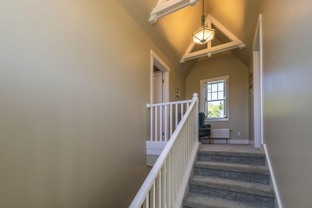 321 Beech Hill Rd, Northport, ME 04849 - staircase featuring lofted ceiling, radiator heating unit, baseboards, and carpet