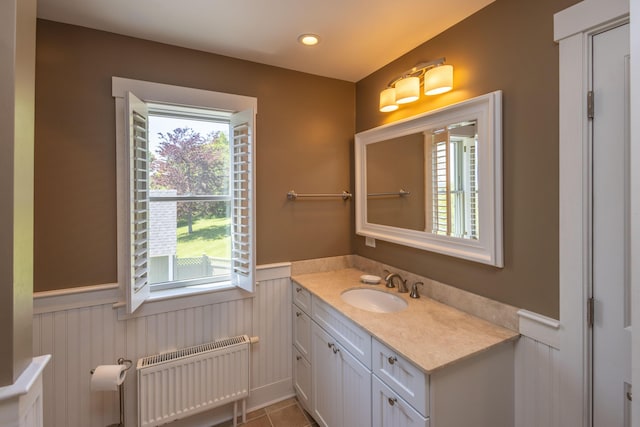 321 Beech Hill Rd, Northport, ME 04849 - bathroom with radiator, wainscoting, vanity, and tile patterned flooring
