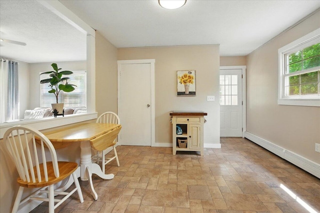 46 Jeffrey St, Lewiston, ME 04240 - dining space featuring light stone finish flooring, baseboards, baseboard heating, and ceiling fan