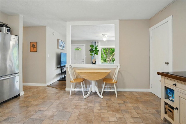 46 Jeffrey St, Lewiston, ME 04240 - dining room with stone tile floors, baseboards, and ceiling fan