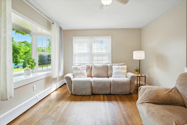 46 Jeffrey St, Lewiston, ME 04240 - living room featuring baseboard heating, a ceiling fan, wood finished floors, and baseboards