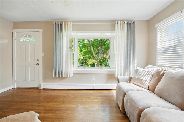46 Jeffrey St, Lewiston, ME 04240 - living room featuring wood finished floors, baseboards, and a baseboard radiator
