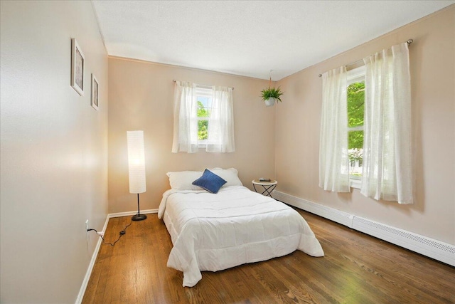 46 Jeffrey St, Lewiston, ME 04240 - bedroom with baseboards, wood finished floors, and a baseboard heating unit