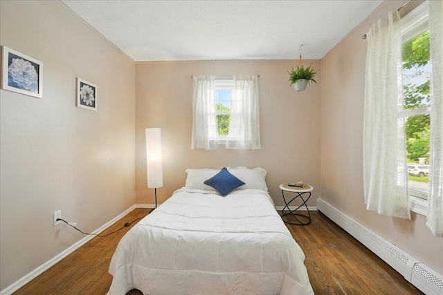 46 Jeffrey St, Lewiston, ME 04240 - bedroom featuring a baseboard heating unit, baseboards, and wood finished floors