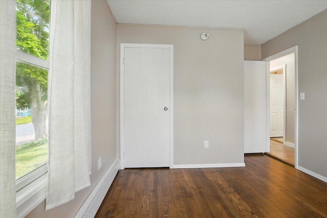 46 Jeffrey St, Lewiston, ME 04240 - unfurnished bedroom with wood finished floors, multiple windows, baseboards, and a closet