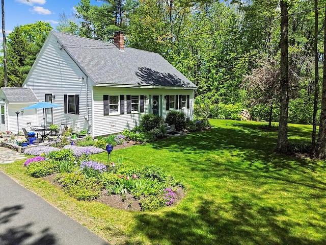 11 Lewis Rd, Sidney, ME 04330 - view of front of property featuring a chimney, a shingled roof, a front lawn, and a patio