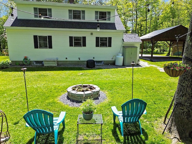 11 Lewis Rd, Sidney, ME 04330 - back of house with a fire pit, a yard, and a shingled roof