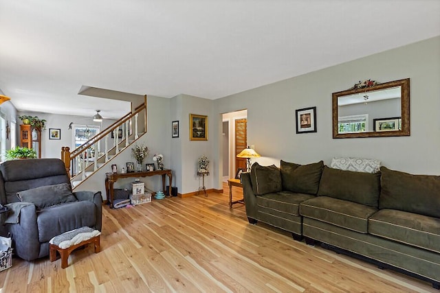 11 Lewis Rd, Sidney, ME 04330 - living room with light wood-style flooring, stairs, baseboards, and ceiling fan