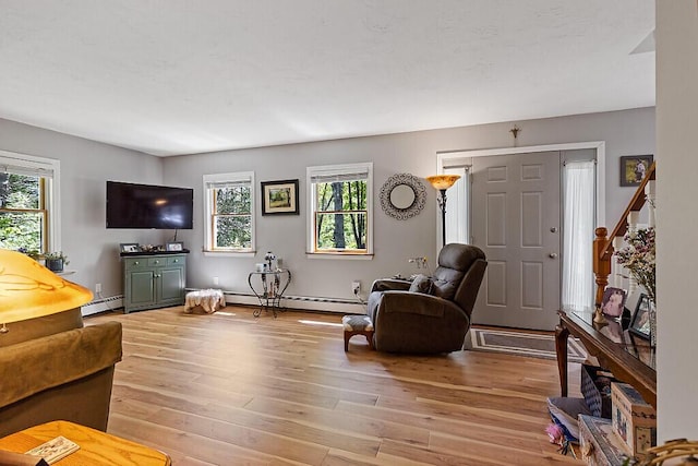 11 Lewis Rd, Sidney, ME 04330 - living room with healthy amount of natural light, light wood-type flooring, and baseboard heating