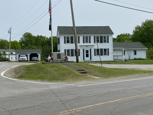 13 Main St, Cambridge, ME 04923 - view of front of home featuring a front lawn, a detached carport, and driveway