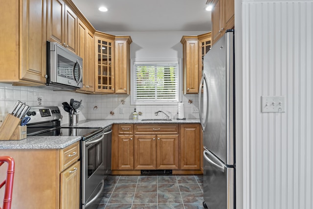 60 Barrell Ln Unit 1, York, ME 03909 - kitchen with stainless steel appliances, brown cabinets, glass insert cabinets, light stone counters, and recessed lighting