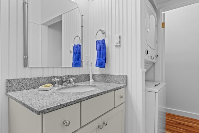 60 Barrell Ln Unit 1, York, ME 03909 - bathroom featuring estacked washer and dryer, vanity, and wood finished floors